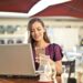 Woman Wearing Purple Shirt Holding Smartphone White Sitting on Chair | GRAMHIR