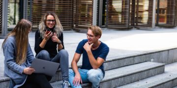 Three Persons Sitting on the Stairs Talking With Each Other | GRAMHIR