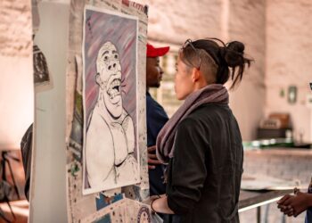 Ethnic woman observing creative artificial intelligence image on exhibition | GRAMHIR