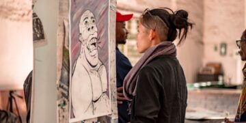 Ethnic woman observing creative artificial intelligence image on exhibition | GRAMHIR