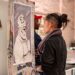 Ethnic woman observing creative artificial intelligence image on exhibition | GRAMHIR