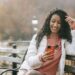 Cheerful Latin American woman with smartphone | GRAMHIR