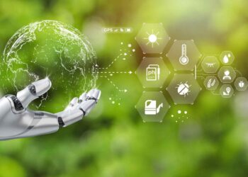A robotic hand holds a transparent globe, with various icons and data points radiating from it, including GPS, temperature, PH scale, and agricultural symbols. The background features a blurred green nature setting, seamlessly blending Climate AI technology with the environment. | GRAMHIR