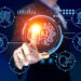 A person in a suit interacts with a virtual interface featuring an illuminated AI symbol at the center. Surrounding icons represent various elements of artificial intelligence, including brain graphics, gears, and personal finance charts, all set against a dark blue background. | GRAMHIR