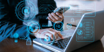 A person in a suit uses a smartphone and laptop, surrounded by digital interface elements and data graphics, symbolizing technology, proxies, and seamless data integration. | GRAMHIR