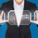 A person in a black suit and white shirt holds transparent panels showing a digital key icon and circuit patterns, symbolizing how proxies help protect intellectual property. The blue background emphasizes the themes of technology and security. | GRAMHIR