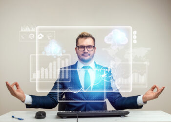 A man in a suit sits at a desk in a meditation pose, eyes open, with digital graphs, AiSDR, and cloud computing icons floating before him, representing calm and control in a high-tech business environment. | GRAMHIR