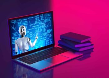 A robot points at scientific formulas on a laptop screen beside a stack of books, lit by pink and blue light.