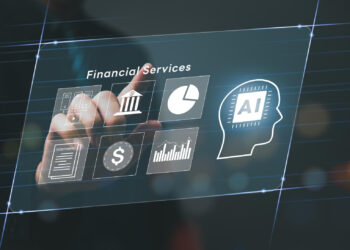 A person’s hand touches a transparent virtual screen displaying icons for financial services, including a bank, pie chart, AI head silhouette, contract, dollar sign, and financial graphs. | GRAMHIR