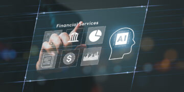 A person’s hand touches a transparent virtual screen displaying icons for financial services, including a bank, pie chart, AI head silhouette, contract, dollar sign, and financial graphs. | GRAMHIR